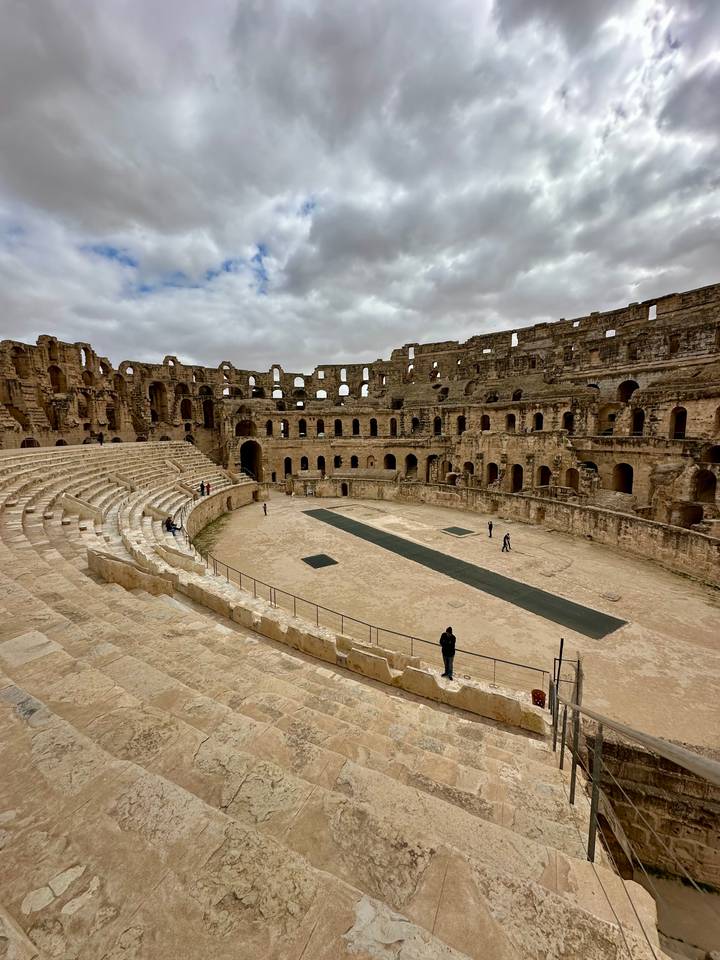 Interior view of the well-preserved Roman amphitheatre at El Jem showing tiered seating and arena floor.