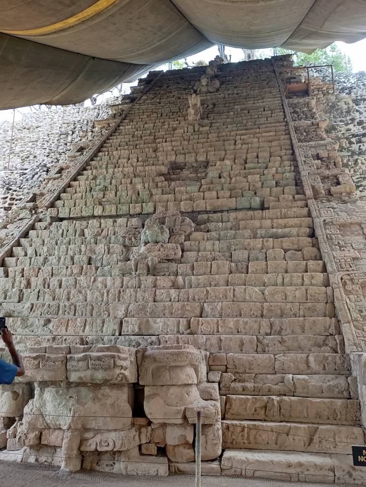 Close view of ancient Mayan stone step structure with eroded carvings