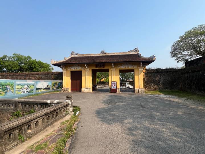 Yellow entrance gate into the Hue Imperial Citadel complex on a bright day.