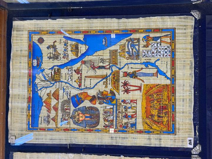 Detailed illustrated papyrus map of Egypt featuring pharaonic imagery and Nile River route.