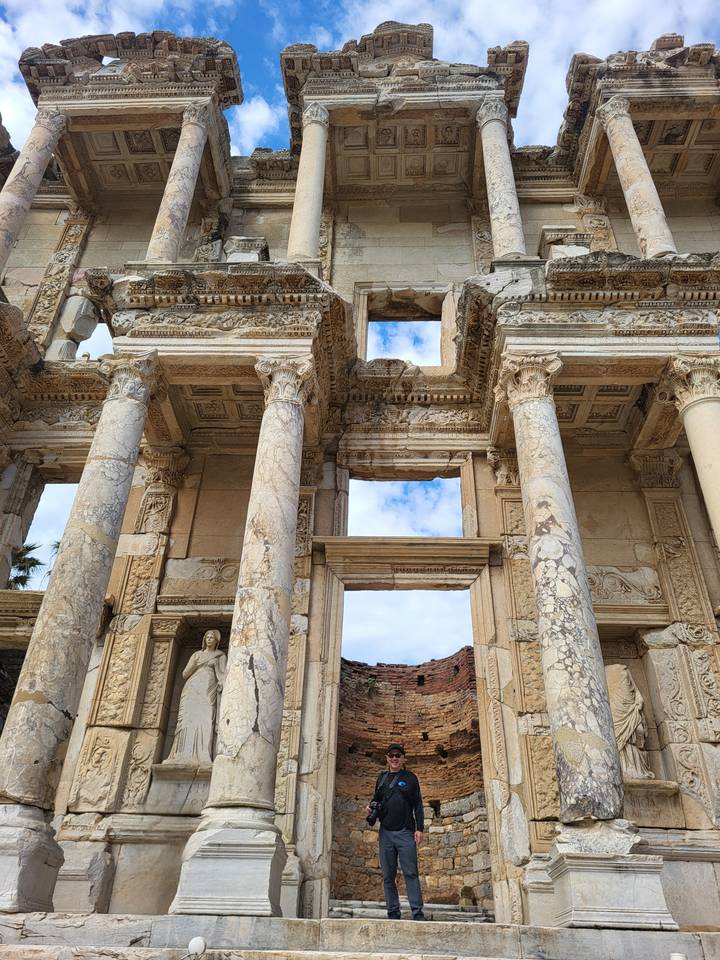 Detailed marble columns and ornate carvings of the Library of Celsus in Ephesus against the sky.