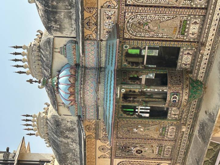 Intricate decorative pavilion on a palace rooftop featuring mirror and mosaic inlay work.