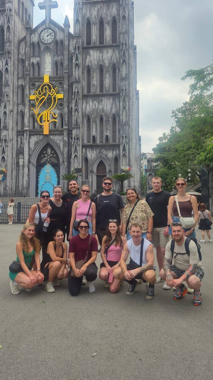 Tour group poses before the Gothic façade of St. Joseph’s Cathedral in Hanoi.