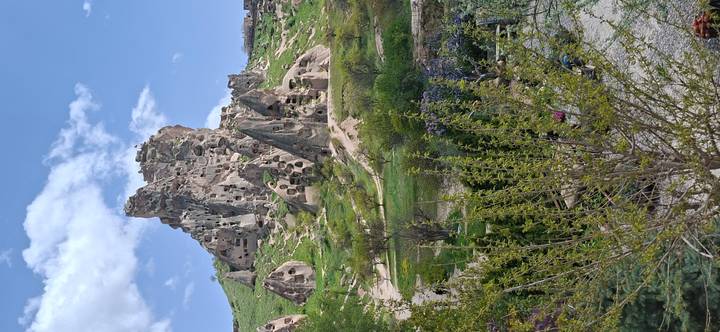 Jagged volcanic tuff castle riddled with cave dwellings rising above Cappadocia landscape