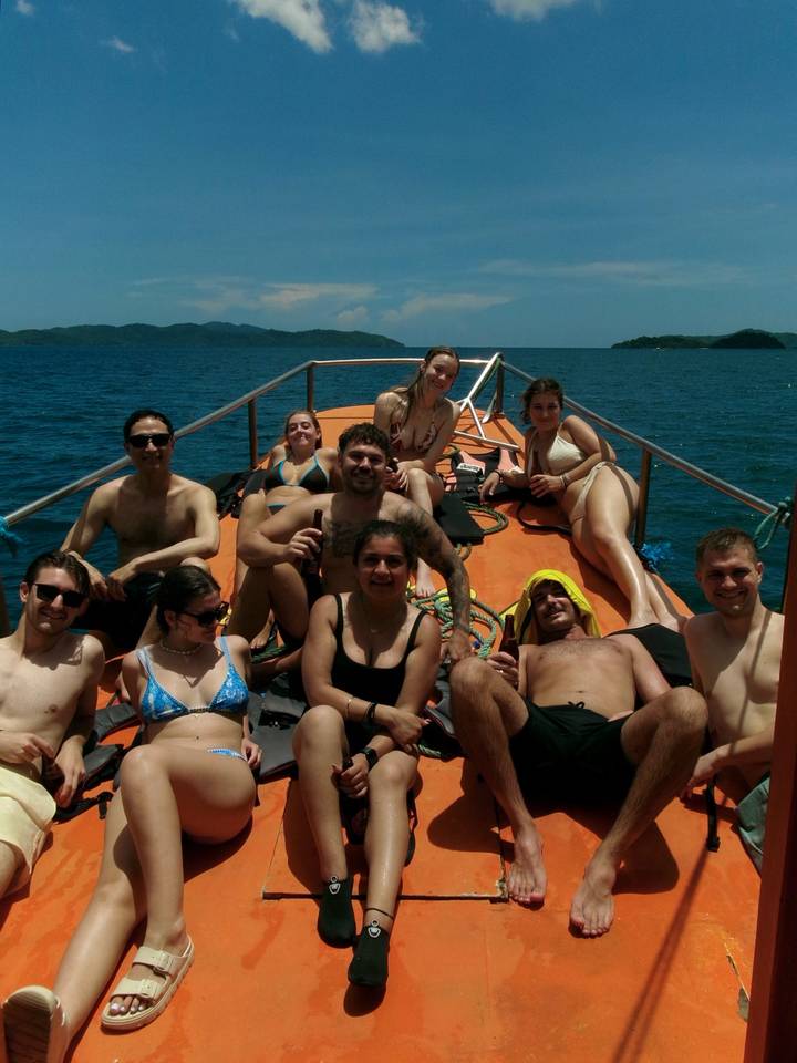 Young travellers relaxing on deck of small boat in open sea on a sunny day