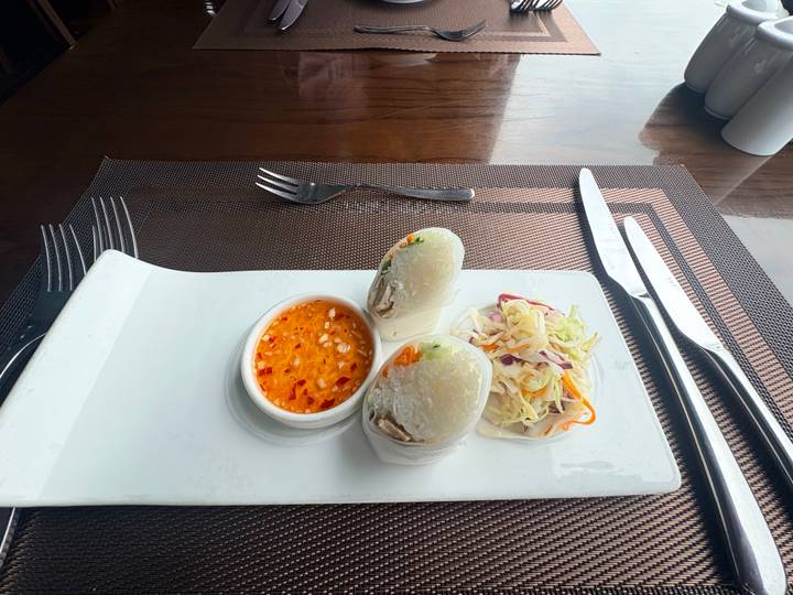 Fresh Vietnamese spring rolls served with sweet chilli dipping sauce on a rectangular plate.