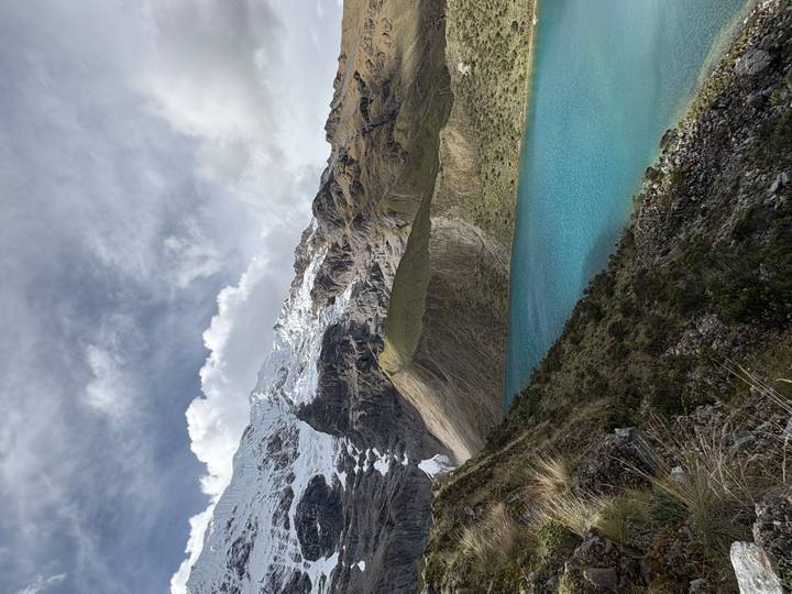 Turquoise Humantay Lake sits beneath snow-capped peaks and rugged brown ridges on the Salkantay trek.