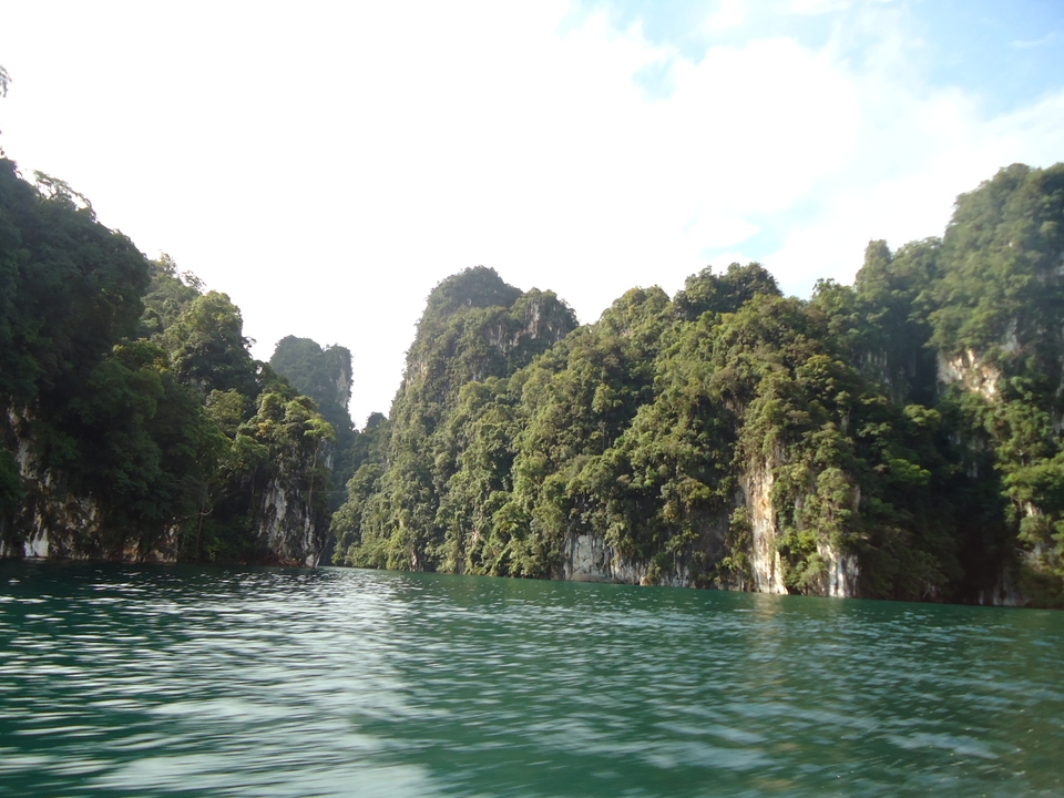 Lush forested cliffs surrounding a lake.