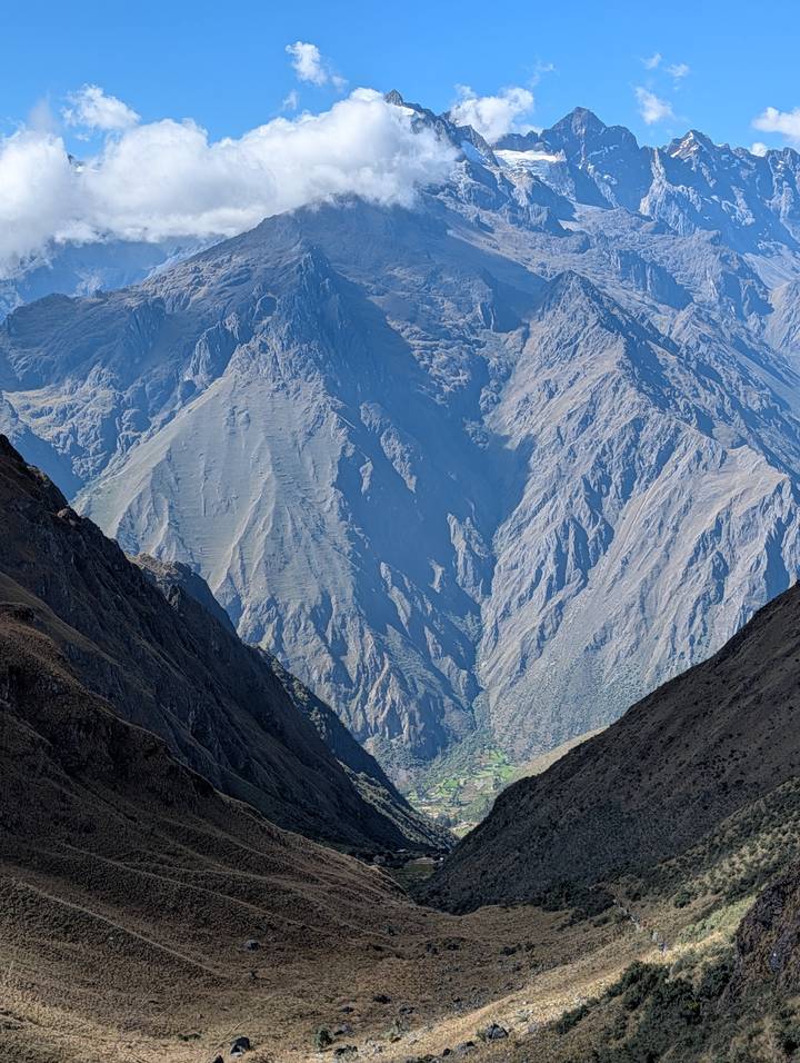 Dramatic Andean ridges display layers of rock and shadow under bright daylight.