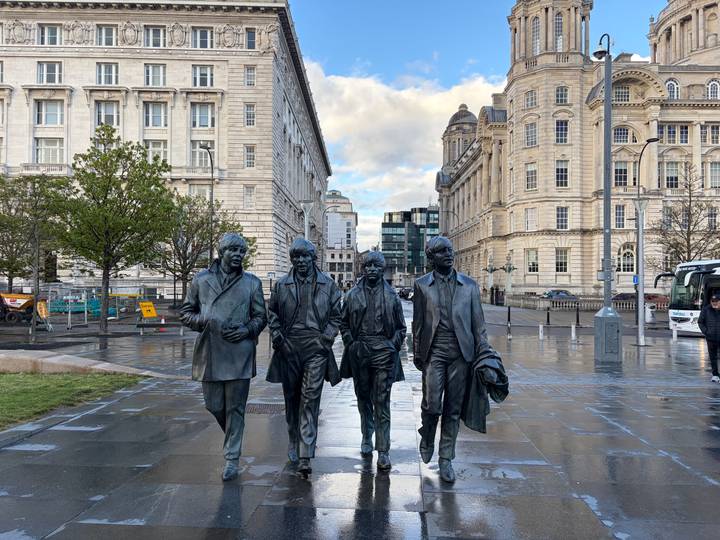 Bronze statues of The Beatles on Liverpool’s waterfront promenade after rain