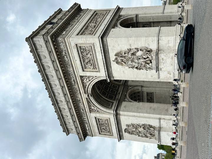 Close perspective of the Arc de Triomphe showing ornate reliefs and archway.
