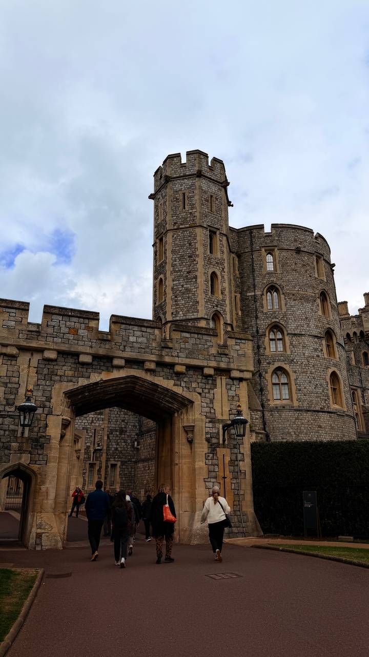 Stone gateway and towers at Windsor Castle display Gothic windows and weathered masonry.