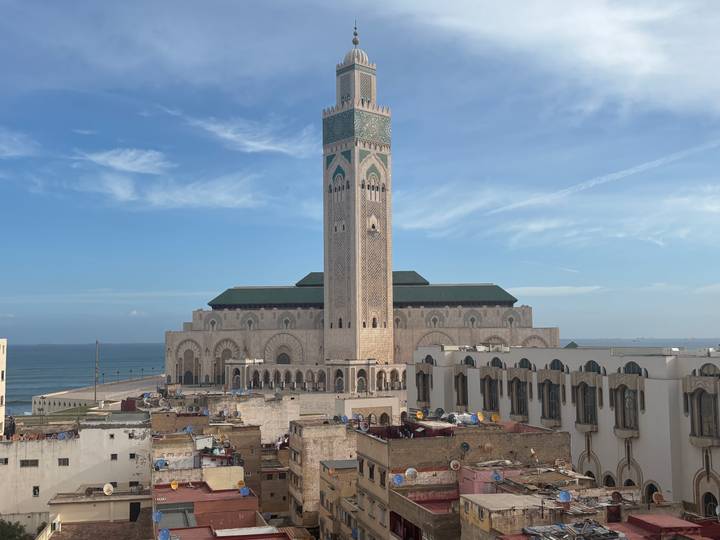 Rooftop view of the Hassan II Mosque complex bordering the Atlantic Ocean in Casablanca.