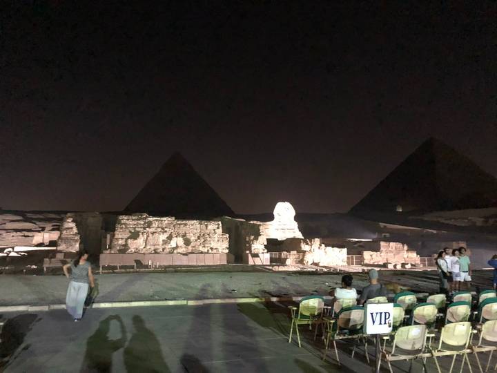 Audience seated for the Giza sound-and-light show with pyramids and Sphinx dimly illuminated.