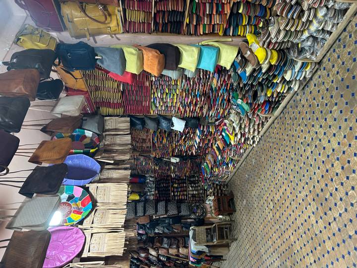 Stacks of vividly coloured leather slippers and handbags fill every inch of a tiny medina shop.