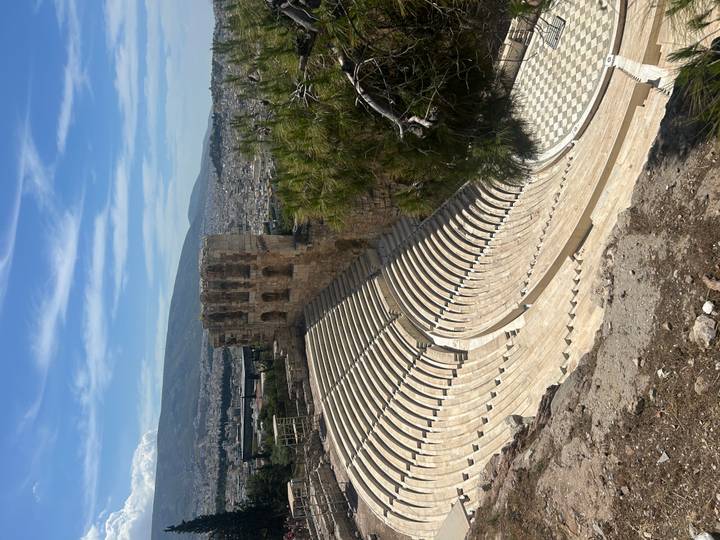 Sweeping view of the semicircular stone seating of the Odeon of Herodes Atticus on the Acropolis hillside.