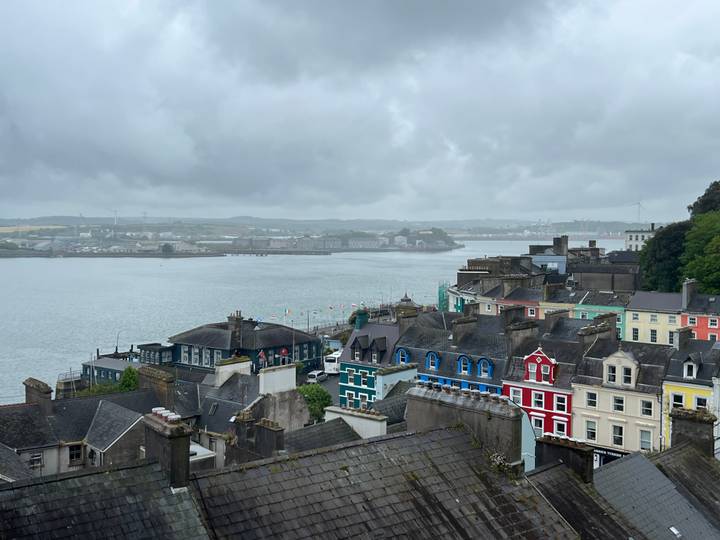 Elevated view over colourful waterfront houses and harbour on a misty day