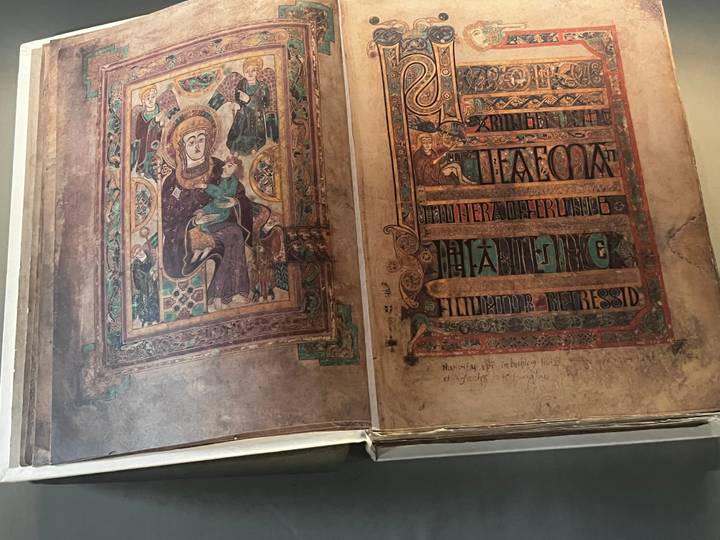 Detailed pages of an ornate medieval illuminated manuscript on display
