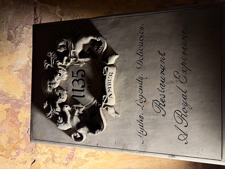 Decorative metal sign for the restaurant '1135 AD Amber' with heraldic lions and ornate script