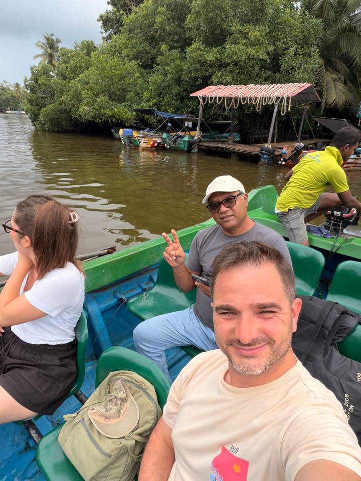 Casual selfie on a green river boat with guide flashing a peace sign.