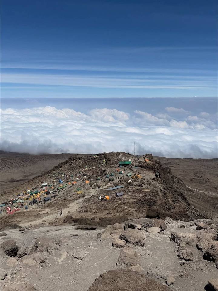 High-altitude camp on Mount Kilimanjaro above a sea of clouds.