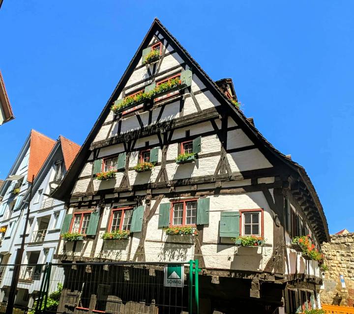 Traditional half-timbered house with flower boxes under clear blue sky