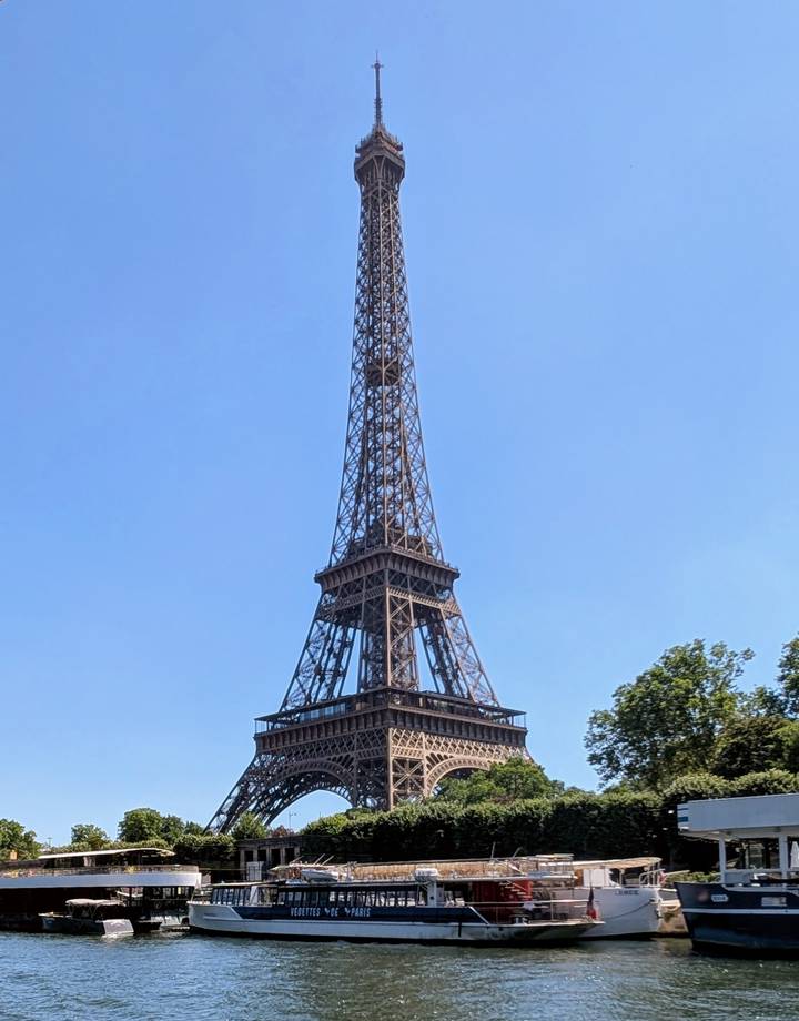 Clear daytime shot of the Eiffel Tower against a cloudless sky