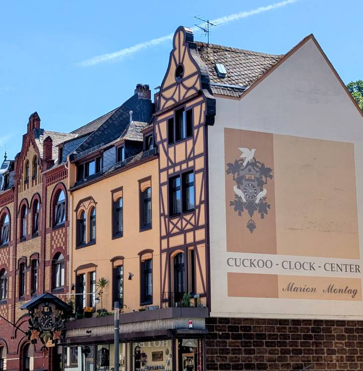 Facade of a building labelled 'Cuckoo Clock Center' with traditional timber designs