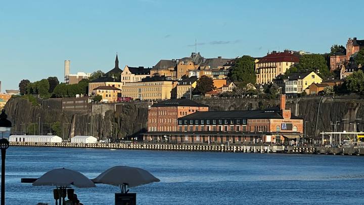 Scenic waterfront skyline of Stockholm’s Södermalm district viewed across blue harbor water.