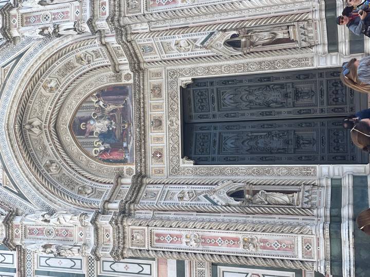 The ornate marble doorway and frescoes of Florence’s Duomo draw visitors’ attention.