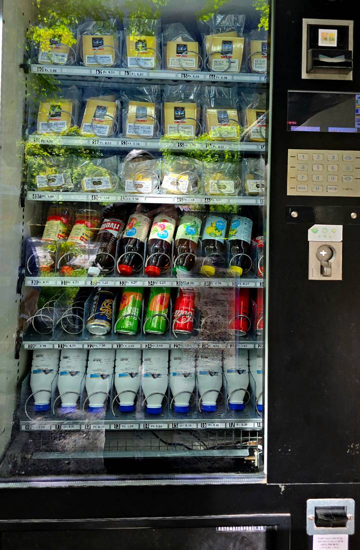 Close-up of refrigerated vending machine filled with assorted soft drinks