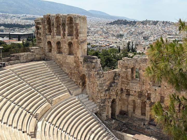 Stone tiers of the Odeon of Herodes Atticus overlooking sprawling Athens cityscape