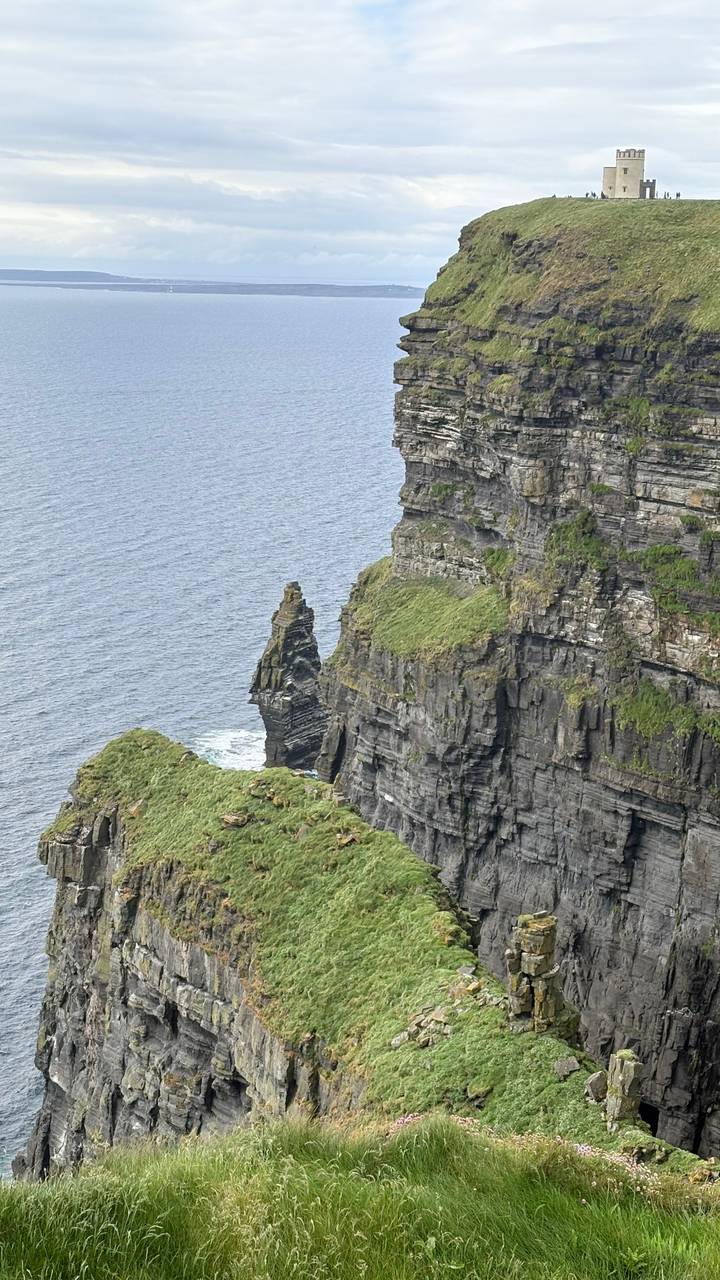 Dramatic ocean cliffs with sea stack and layered rock faces along the Atlantic coast