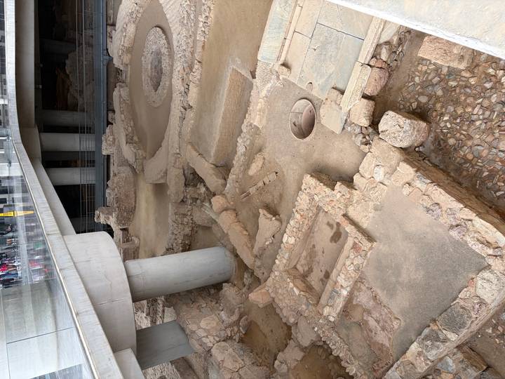 Excavated ancient foundations displayed beneath the modern Acropolis Museum.