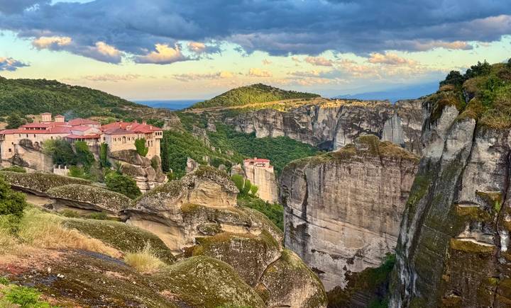 Sunlit monasteries perched on towering sandstone cliffs at Meteora.
