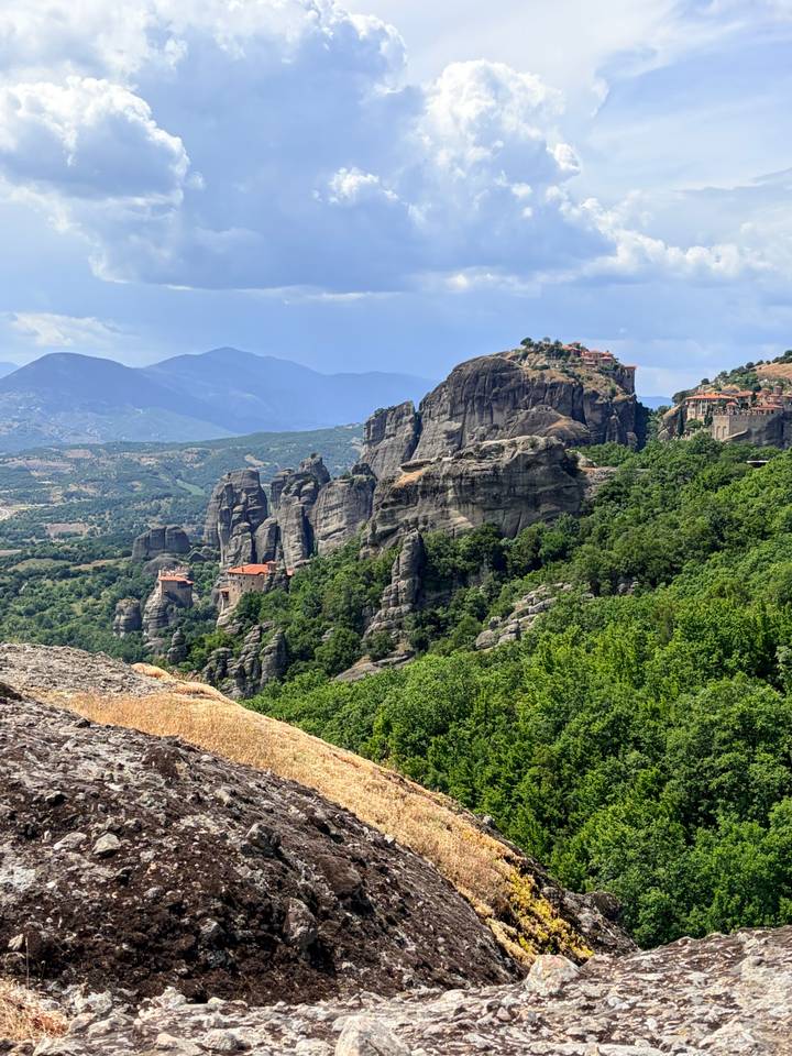 Dramatic rock pillars crowned with monasteries rise above verdant forests at Meteora.