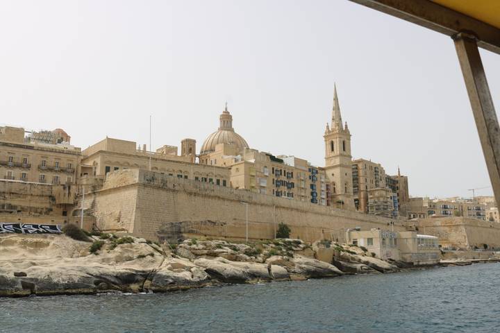 Valletta’s sandstone bastions, dome and spire viewed from the water