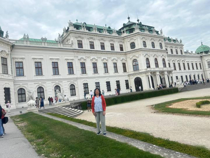 Visitor poses outside the grand Baroque façade of Vienna’s Belvedere Palace.