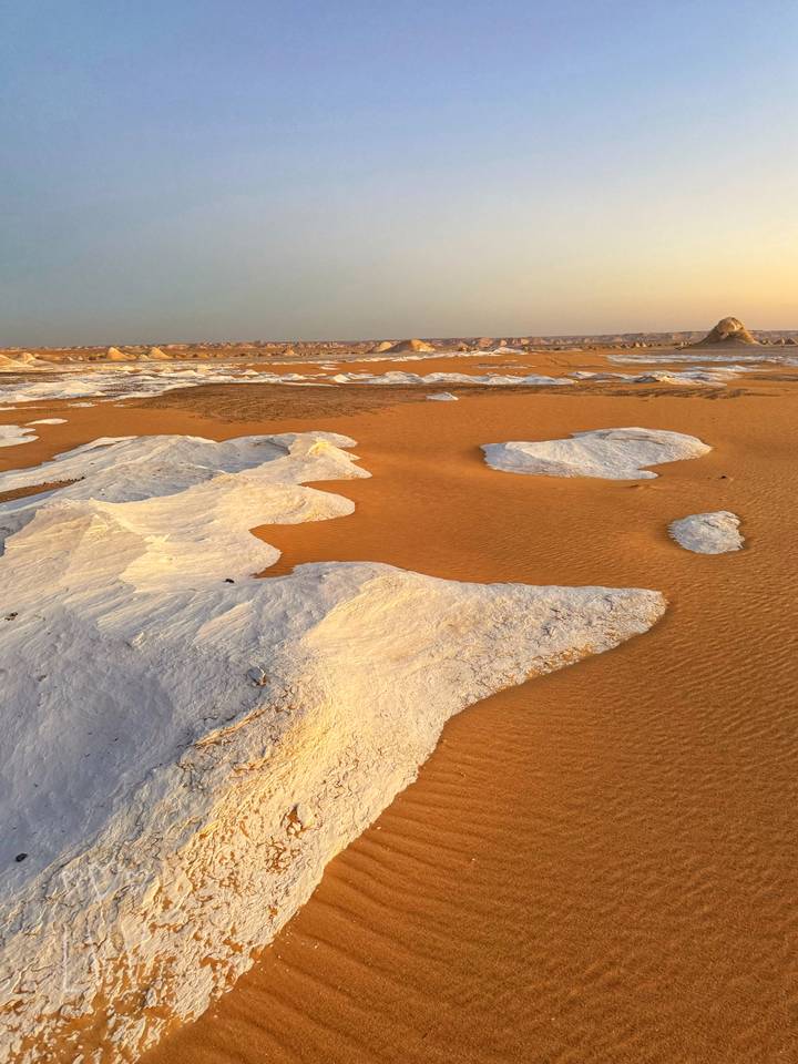 Orange sand plains dotted with white chalk islands stretching to the horizon