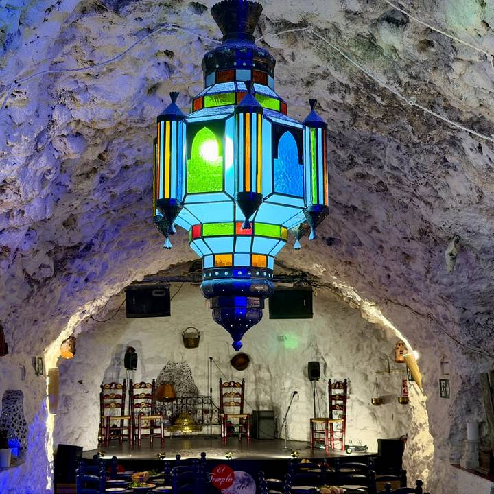 Colourful lantern hanging from a whitewashed cave ceiling in a flamenco bar.