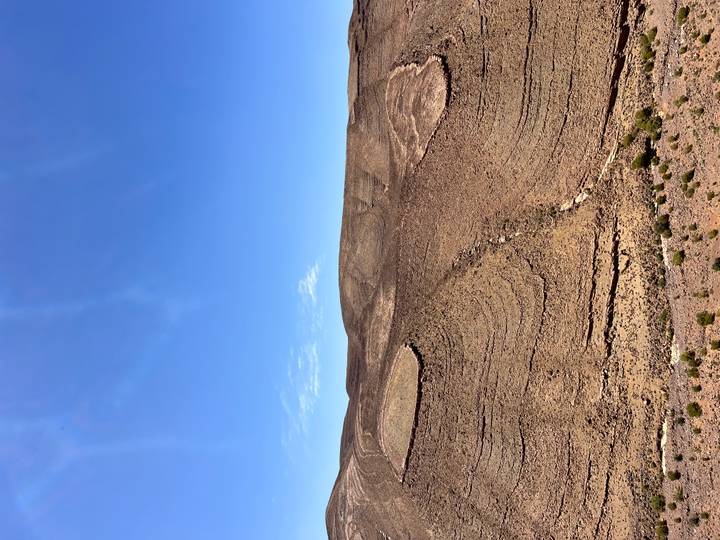 Barren rocky plateau under a cloudless bright blue sky in the Moroccan desert