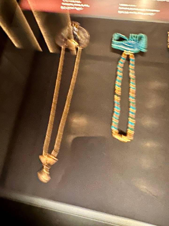 Out-of-focus display case with ancient jewelry pieces