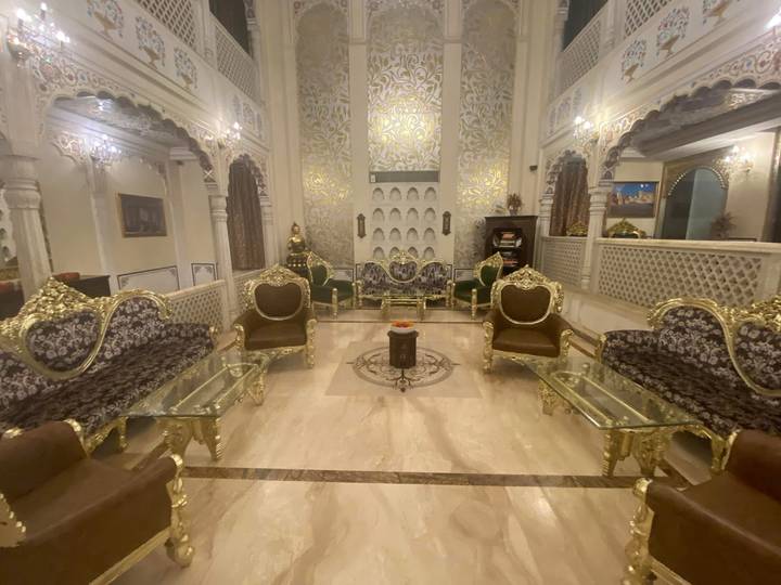 Opulent hotel lounge with gilded furniture, marble floors and intricate wall carvings
