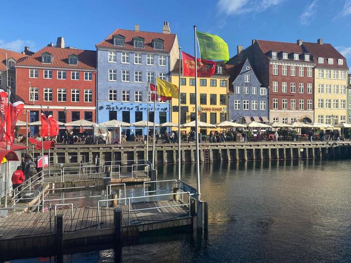 Colorful historic buildings and lively cafés line the opposite side of Copenhagen’s Nyhavn canal.