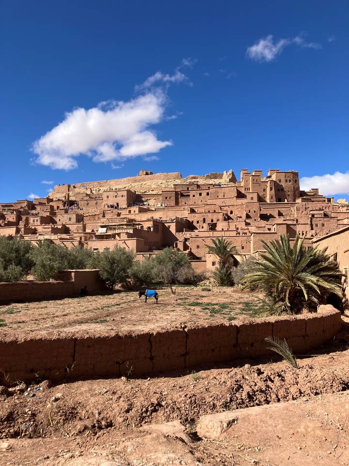 Clay-brick fortress village of Ait Benhaddou beneath vivid blue sky