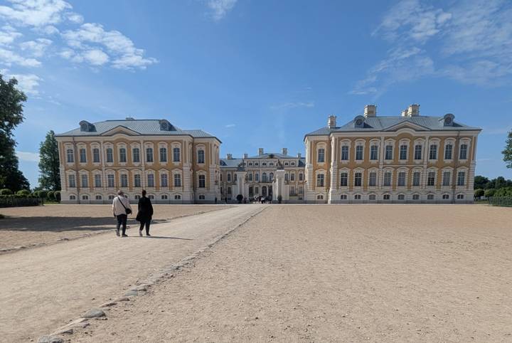 Expansive view of Rundale Palace with two visitors walking up central path