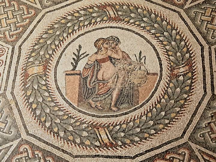 Detailed ancient Roman mosaic of an embracing couple, Sicily.
