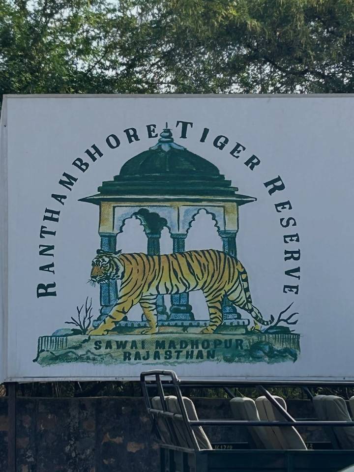 Illustrated signboard for Ranthambhore Tiger Reserve featuring a tiger beneath an arch.