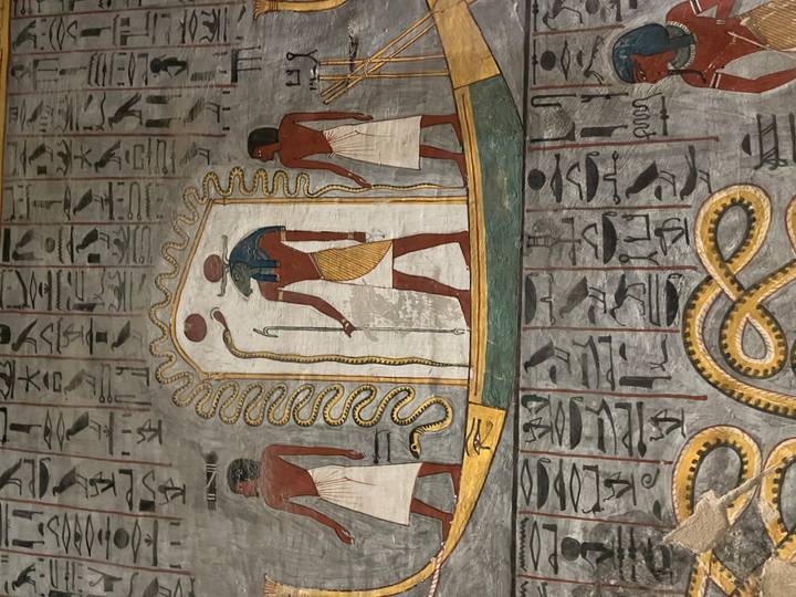 Detailed vertical mural of Egyptian deities with hieroglyphics on a tomb wall.
