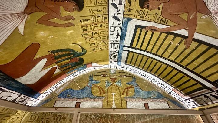 Vividly painted pharaonic ceiling with ancient Egyptian gods and hieroglyphs.